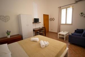a bedroom with a bed with towels on it at Karyba House in Lampedusa