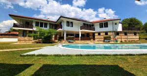 a large house with a swimming pool in front of it at Hotel Aleksandrina in Kipilovo