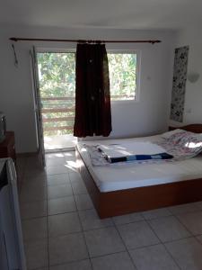 a bedroom with a bed and a window at vila catrini in Costinesti
