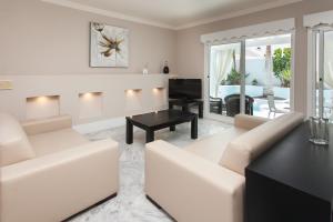 a living room with a white couch and a table at Villa 44 in Corralejo