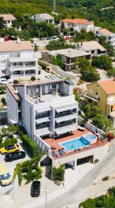 an aerial view of a building with a swimming pool at Apartments Villa Manda in Novi Vinodolski