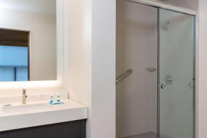 a bathroom with a shower and a sink at Hyatt House Austin/Downtown in Austin