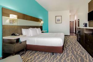 a hotel room with a large bed and a television at La Quinta Inn & Suites by Wyndham Northlake Ft. Worth in Northlake