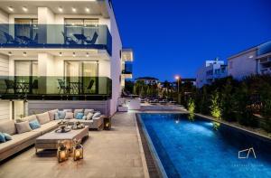 a villa with a swimming pool at night at Luxury Apartments in Villa Curiera in Malinska