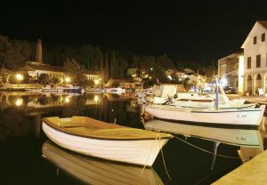 a group of boats docked in a harbor at night at Villa Welcome in Vrboska
