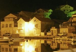 a group of boats in a harbor at night at Villa Welcome in Vrboska