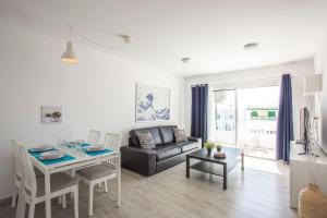 a living room with a couch and a table at Lanzahost Tabayba Sun in Costa Teguise