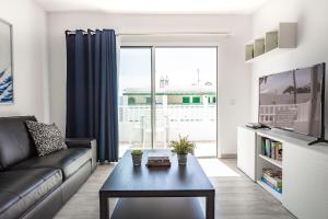 a living room with a couch and a table at Lanzahost Tabayba Sun in Costa Teguise