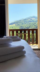 a white bed with a view of a mountain at Le Brunet in Saint-Jacques-des-Blats