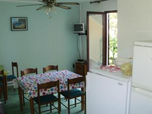 a kitchen with a table and chairs and a refrigerator at Villa Welcome in Vrboska