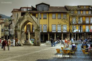 a group of people sitting in chairs in front of a building at Quinta Da Longra in Vizela