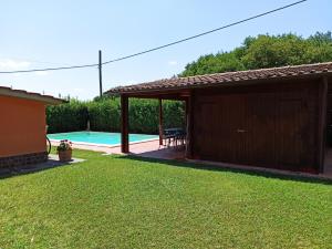 a backyard with a pool and a pavilion at I Sogni di Velia in Tuoro sul Trasimeno