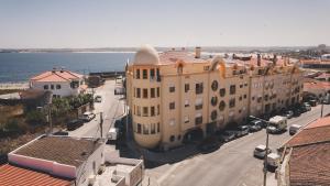 an aerial view of a building next to the water at Peniche Beach House in Peniche