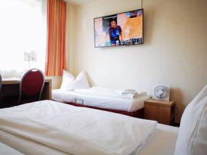 Postel nebo postele na pokoji v ubytování Hotel Scholz