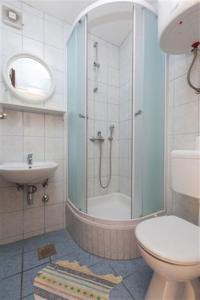 a bathroom with a shower and a toilet and a sink at Apartments Marino Gojak in Makarska