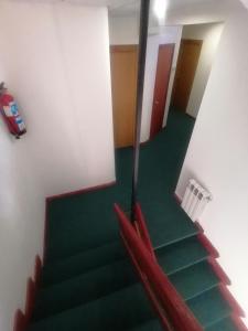 a view of a staircase with green flooring and a room at Hotel Besaya in Torrelavega