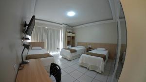 Un ou plusieurs lits dans un hébergement de l'établissement Hotel Desbravador
