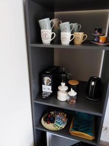 a shelf with cups and other items on it at **Auszeit am Kaiser** in Walchsee