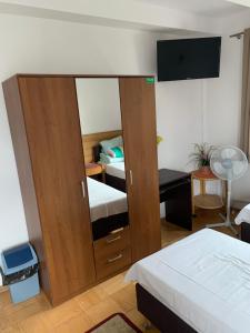 a room with two beds and a door with a mirror at Kwatery Pracownicze TOLEK in Warsaw