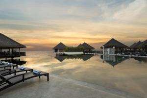 a resort swimming pool with a view of the ocean at Golden Palm Tree Sepang in Sepang