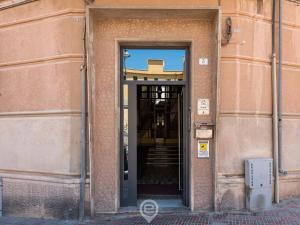 an open door to a building with a staircase at Manì Rooms Villanova in Cagliari