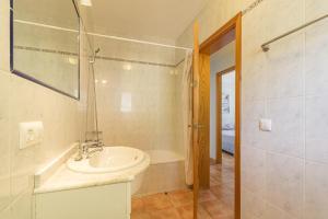 a bathroom with a sink and a shower and a tub at Villa Novas Park in Son Parc +31 photos