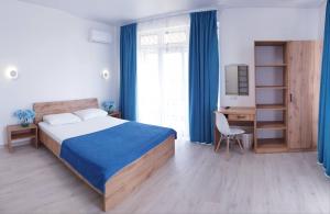 a bedroom with a bed and a desk with a computer at Zatokas Sun Club in Zatoka +232 photos