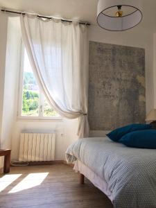 um quarto com uma cama e uma janela em Casa Mariana em Ghisoni