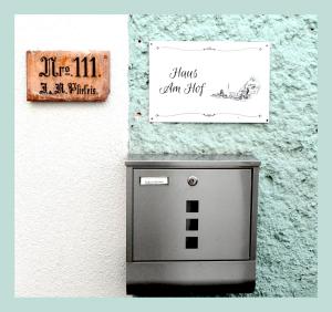 a sign on a wall next to a television at Haus am Hof - 15th century house at the lake, near the marketplace, with a balcony in Hallstatt