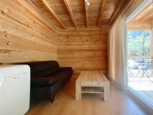 a living room with a couch and a table at Camping Piccolo Paradiso in Avegno