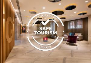 a lobby with a safe tourism sign on the wall at Fer Hotel in Istanbul