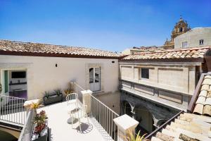 an apartment balcony with a view of a building at A.D. 1768 Boutique Hotel in Ragusa