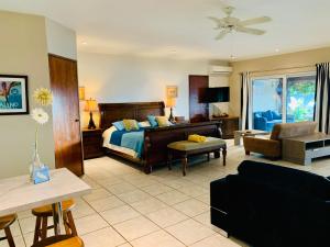 a bedroom with a bed and a living room at Aruba Sunset Beach Studios in Palm-Eagle Beach