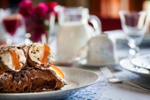 a piece of cake on a plate on a table at La Casa al Sole in Mazara del Vallo +25 photos