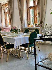 a dining room with a white table and chairs at Hotel Azyl in Gorzów Wielkopolski