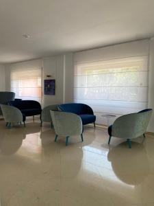 a waiting room with chairs and a table and a window at Hotel La Meridiana in Sorrento