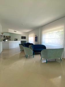 a living room with chairs and a blue couch at Hotel La Meridiana in Sorrento