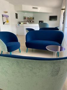 a living room with a blue couch and a table at Hotel La Meridiana in Sorrento