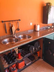 a kitchen counter with a sink and some pots and pans at Quinta da Falfeira in Lagos