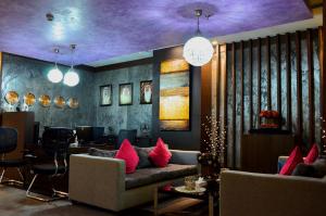 Blaire Executive Suites في المنامة: غرفة معيشة مع أريكة وسقف أرجواني
