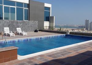 a swimming pool on the roof of a building at Blaire Executive Suites in Manama