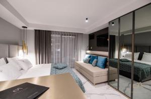 a hotel room with a bed and a couch at Luxury Apartments in Villa Curiera in Malinska +80 photos