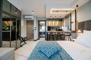 a bedroom with a large bed and a kitchen at Luxury Apartments in Villa Curiera in Malinska