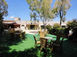 a group of tables and chairs on a lawn at Hotel La Maruxiña in La Alameda de la Sagra
