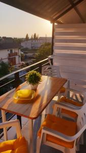 a wooden table and chairs on a balcony at Zatokas Sun Club in Zatoka