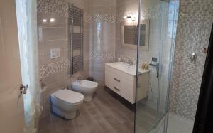 a bathroom with a toilet and a sink and a shower at B & B Villa Fiorella in Termoli +28 photos