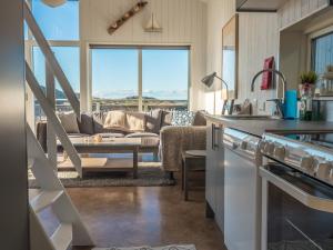 a kitchen and living room with a couch at Hav & Logi Skärhamn in Skärhamn