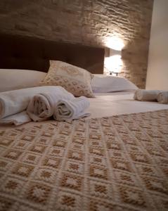 a hotel room with two beds and a rug at Il Lentischio in Cala Gonone