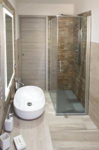 a bathroom with a glass shower and a white sink at Il Lentischio holiday home in Cala Gonone +111 photos