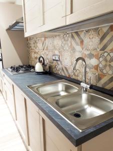 a kitchen with a sink and a stove at Il Lentischio in Cala Gonone